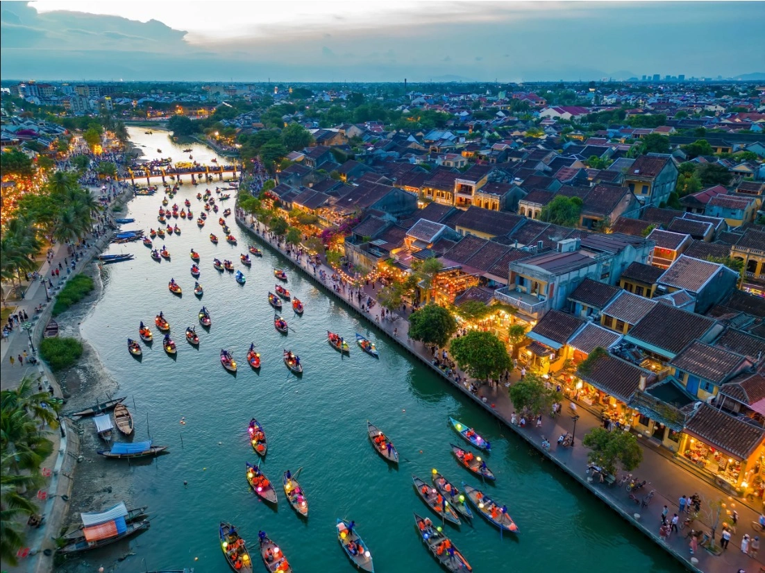 Aerial view of Hoi An Ancient Town with colorful lantern boats on the Thu Bon River, Vietnam