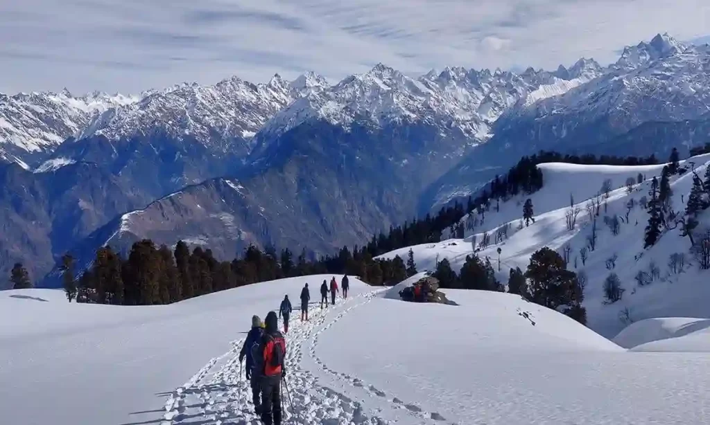 Snow-covered Kedarkantha Peak during a Himalayan trek in Uttarakhand India.